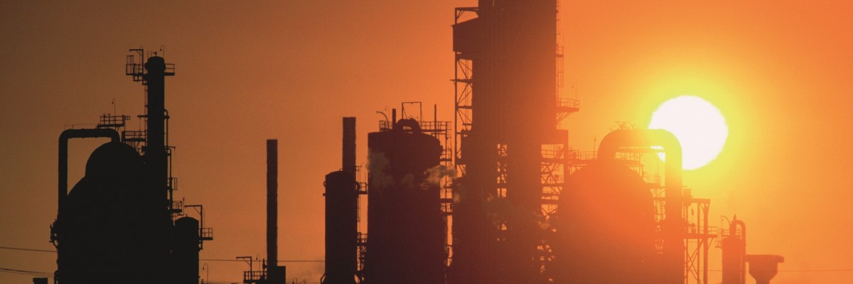 sunrise behind a petrochemical plant